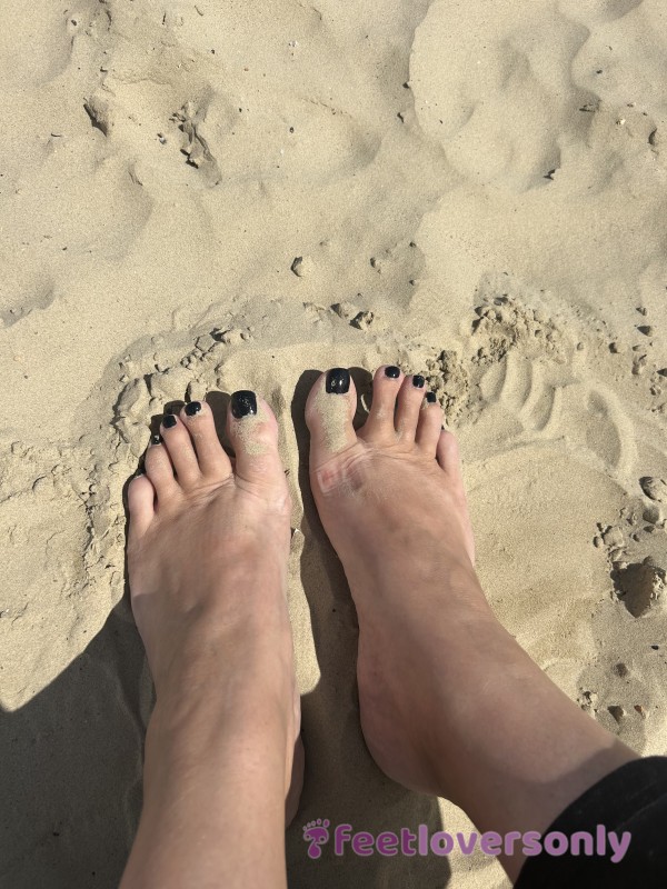 Feet In The Sand On The Beach