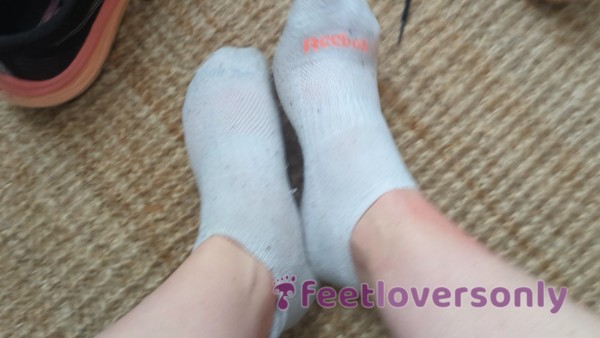 Peeling Of Sweaty Gym Socks, Sweaty White Train Socks. Spreading Toes Wide And Showing Soles And Arches.