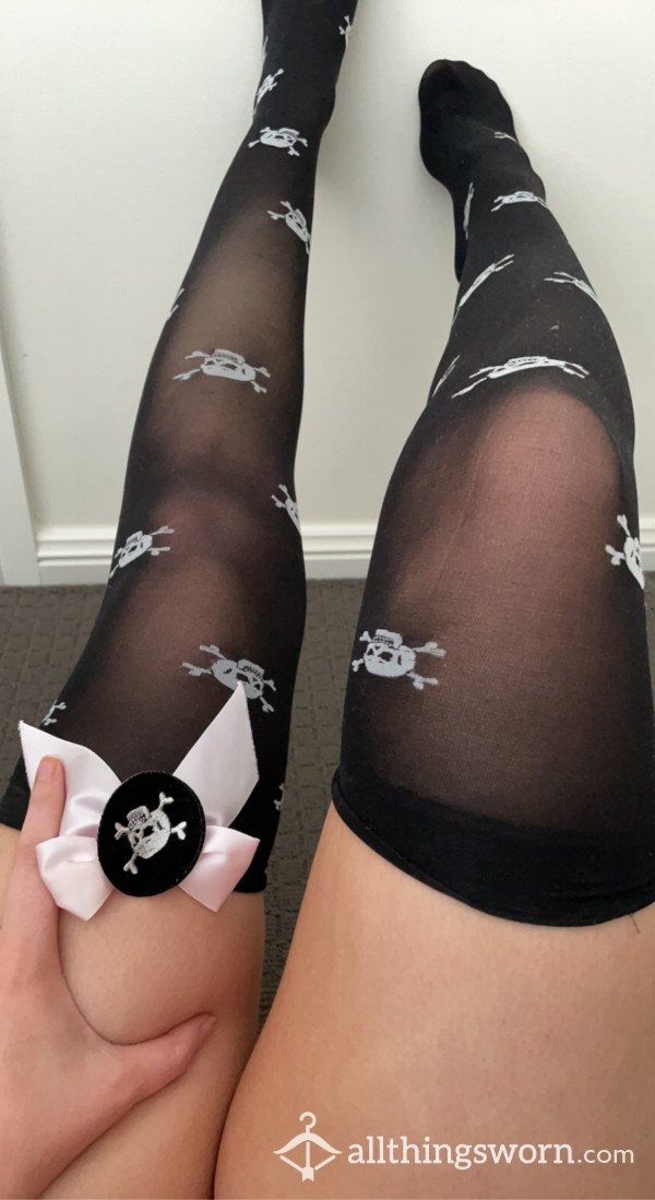 Worn Black Skull Stockings With Pink Bow